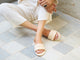 Woman wearing Sugarbird leather slide sandal in macadamia with white pants