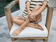 Woman wearing Sunbeam leather flip flop sandal in beach with striped knit dress