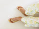 Woman wearing Sunbeam leather flip flop sandals in glow with floral pants