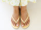 Woman wearing Sunbeam leather flip flop sandals in glow with floral pants