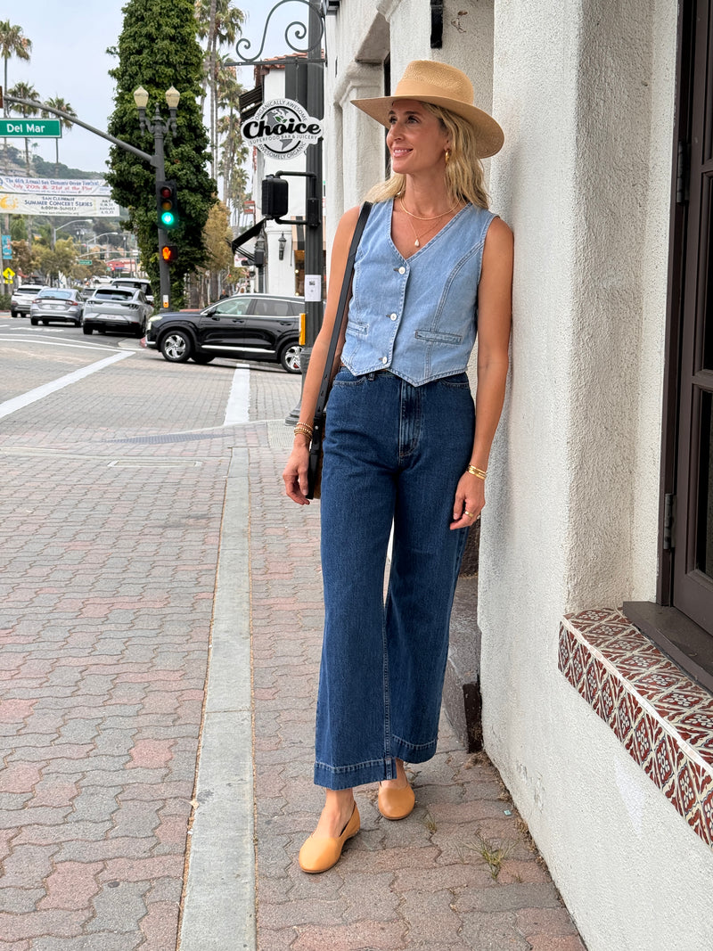 @abbiecrane wearing Swiftlet leather ballet slippers in honey with jeans, denim vest, and hat