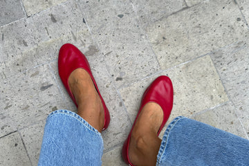 Woman wearing Swiftlet leather ballet slippers in lipstick with jeans