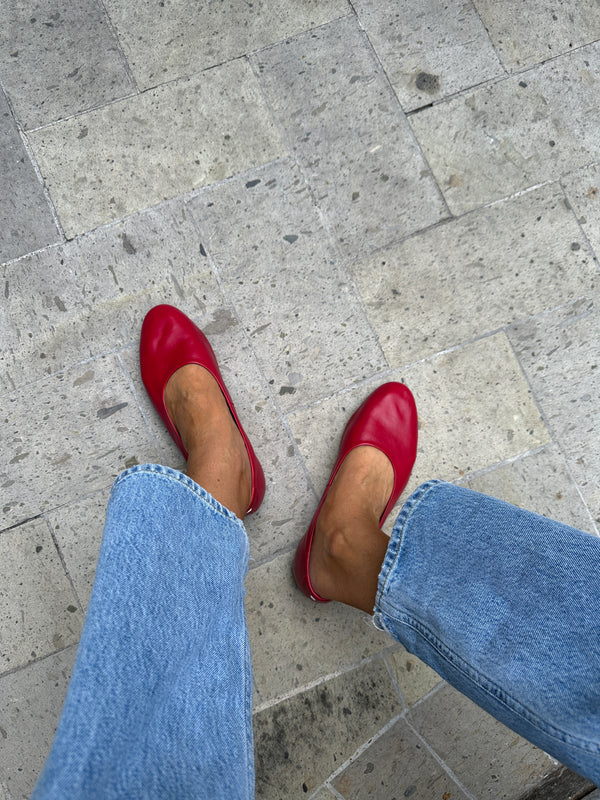 Woman wearing Swiftlet leather ballet slippers in lipstick with jeans