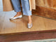 Woman wearing Swiftlet leather ballet slipper in silver with jeans and coat