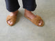 Woman wearing Tesia suede slide sandal in almond with dark jeans