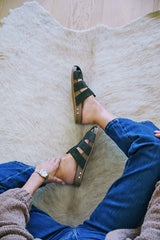 Woman wearing Tody suede slide sandal in moss with jean and sweater