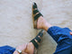 Woman wearing Tody suede slide sandal in moss with jean and sweater