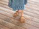 Woman wearing Warbler leather slide sandal in tan with patterned dress